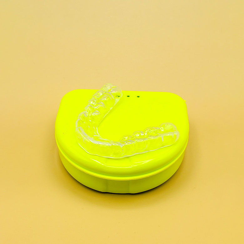 a green frisbee sitting on top of a yellow table 