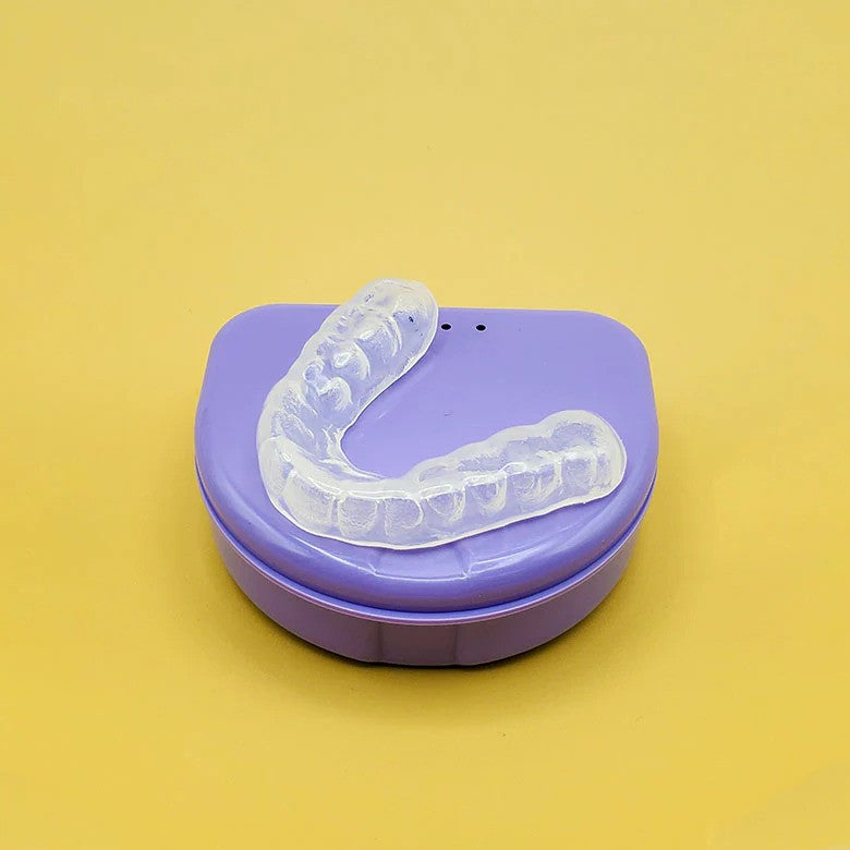 mouthguard sitting on a light purple case