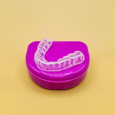 mouthguard sitting on a pink case
