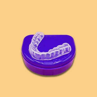 soft durable nighttime mouthguard on top of a blue case